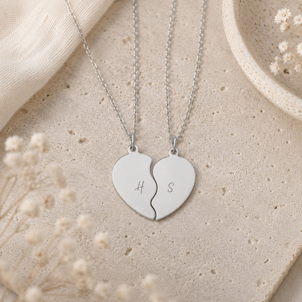 Break apart heart necklace set worn by two people