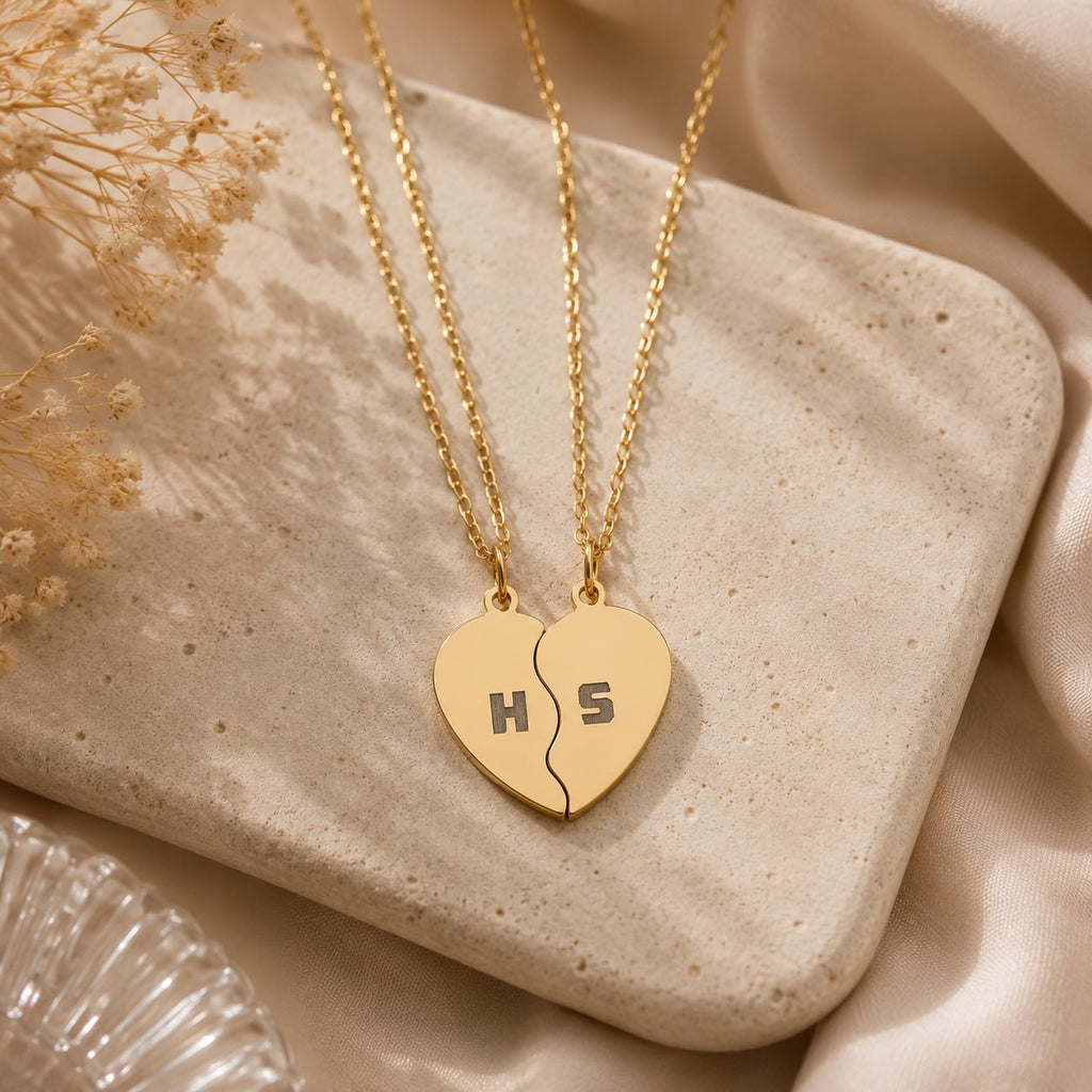 Break apart heart necklace set worn by two people