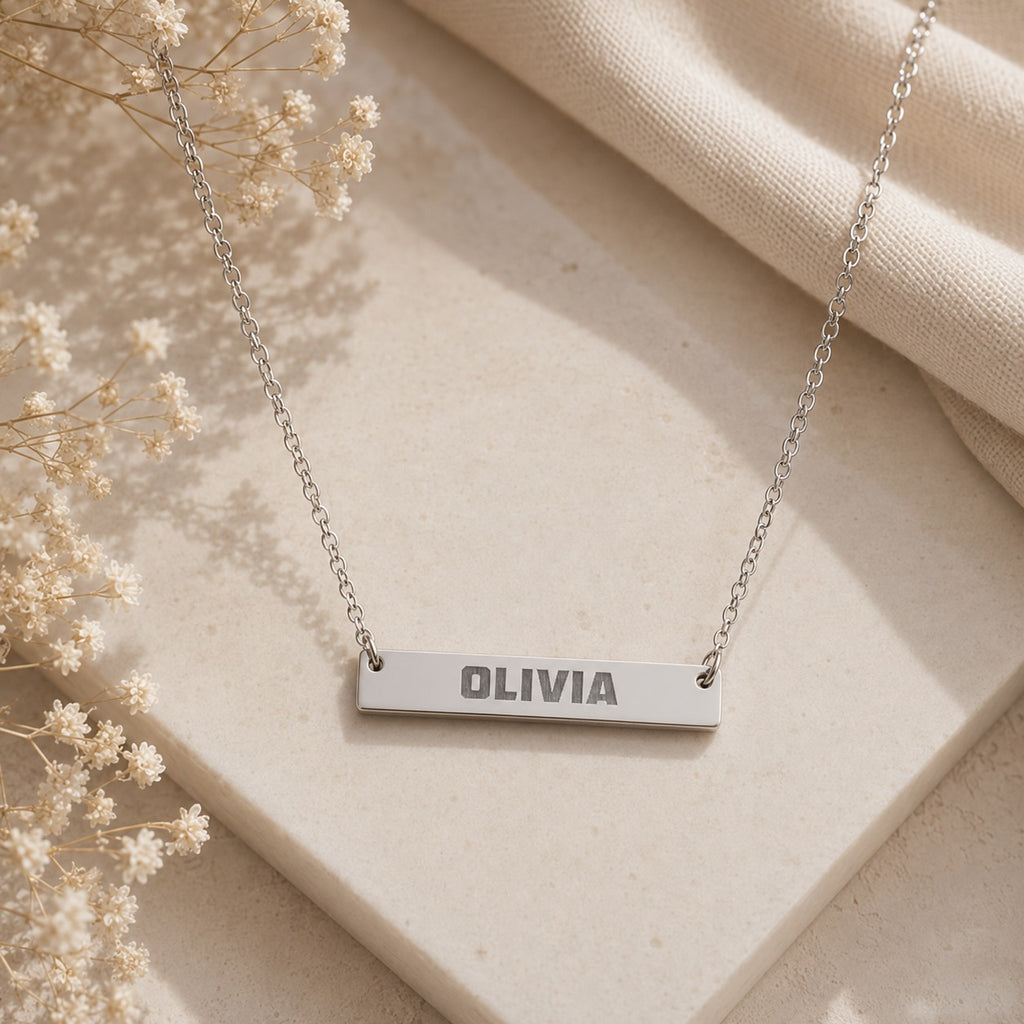 Brushed bar necklace close-up of bold font engraved name