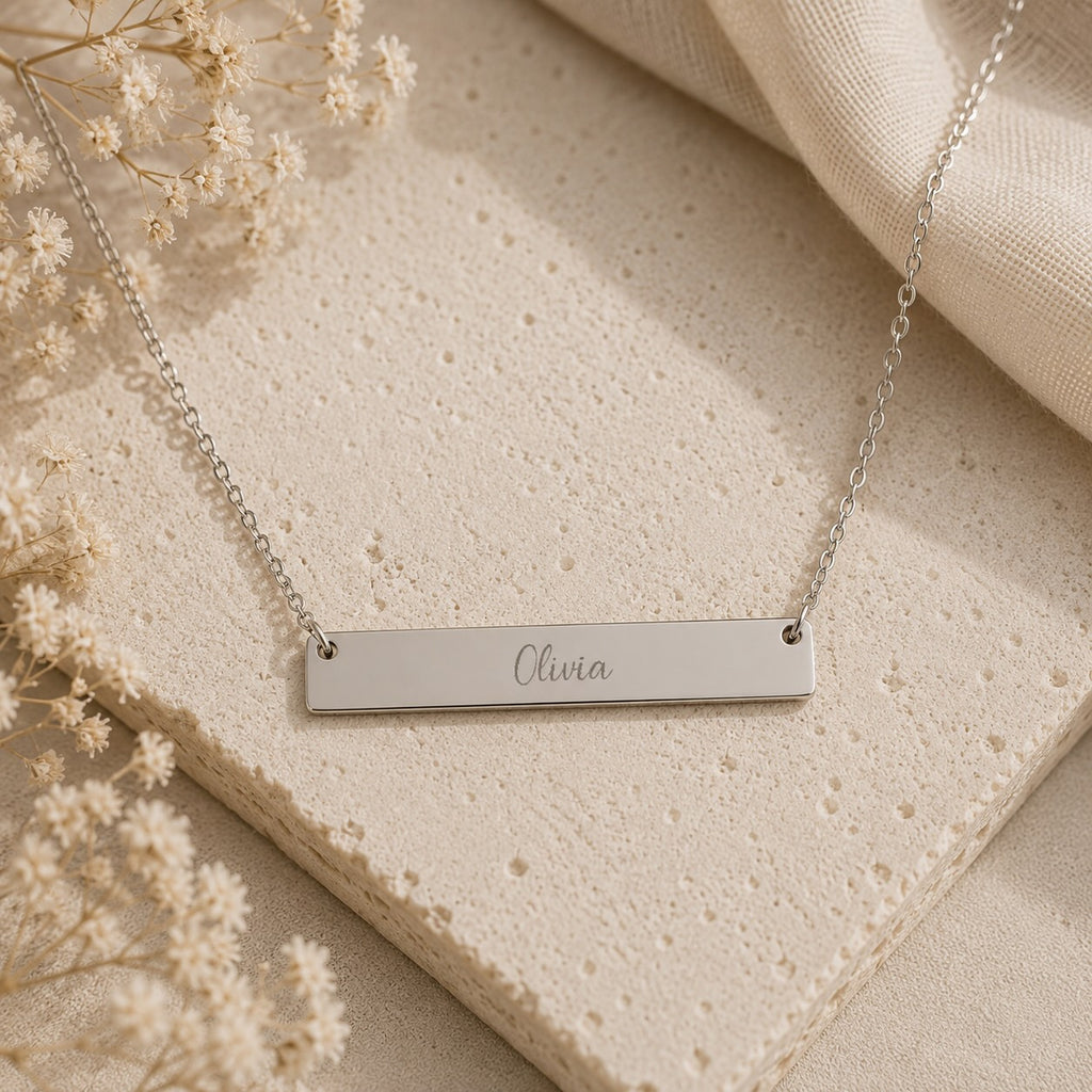 Brushed bar necklace close-up of engraved name detail