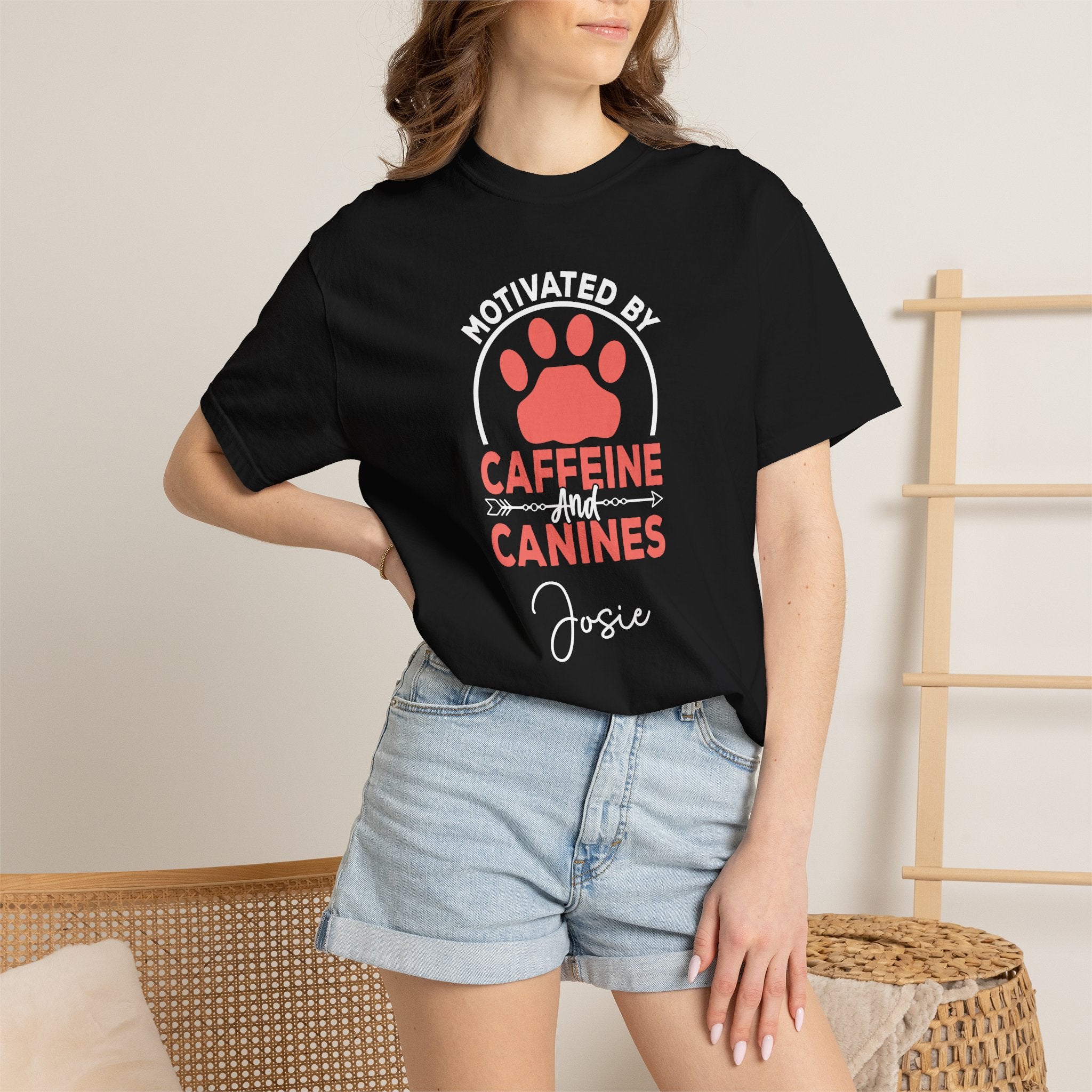 Woman on sofa wearing Caffeine and Canines dog lover tee