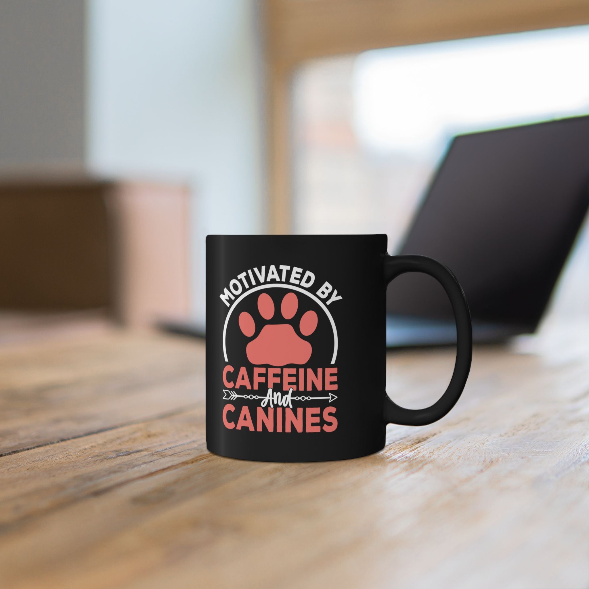Close-up of Motivated by Caffeine and Canines design on black mug