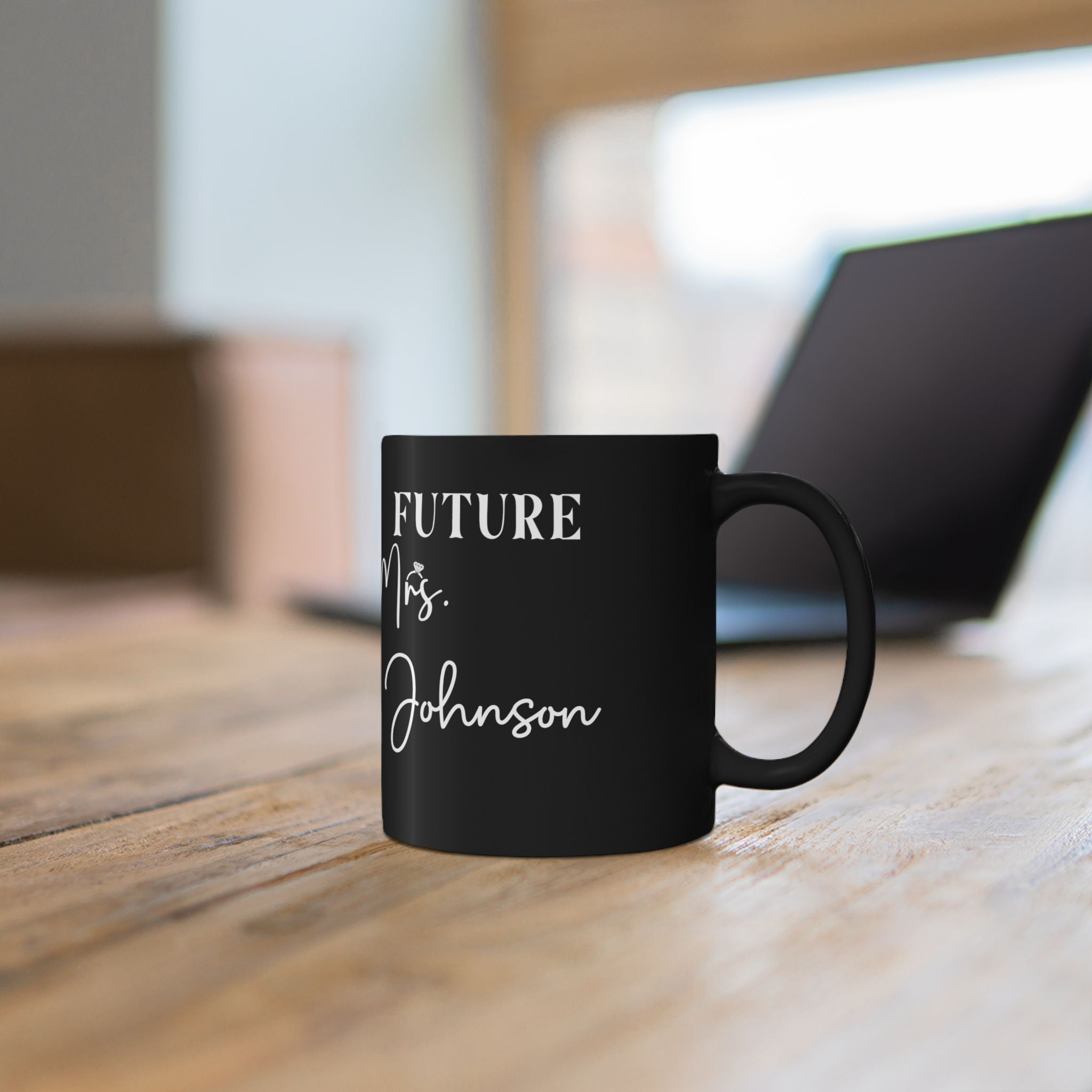 Close-up of Future Mrs. lettering and surname on black mug