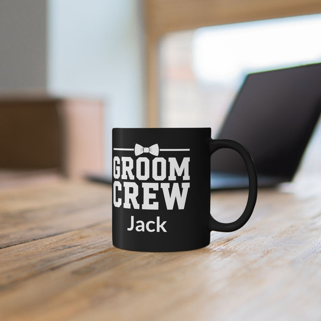 Close-up of Groom Crew lettering and bow tie design on black mug