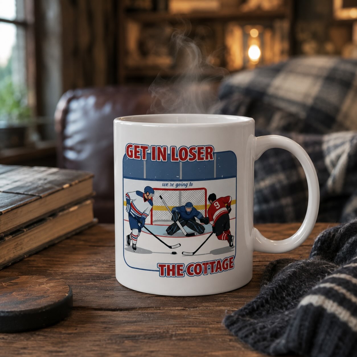 Get in Loser We're Going to the Cottage hockey mug styled on rustic wood table with plaid blanket and books