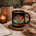 Mamasaurus black mug styled with candle, cookies, and cozy knit blanket