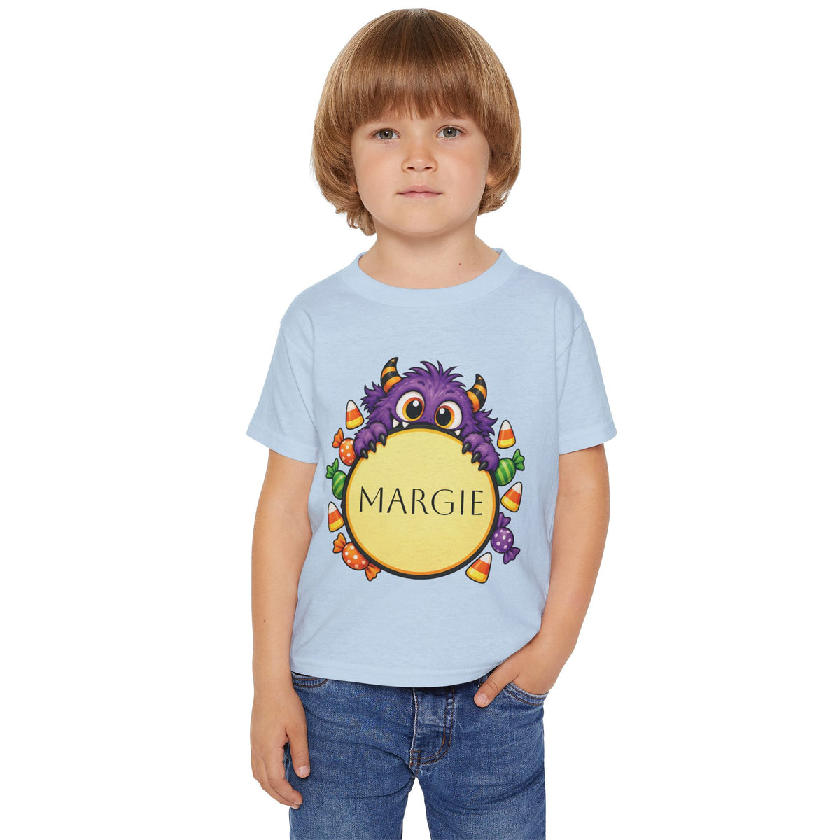 Toddler wearing personalized candy monster Halloween t-shirt at a pumpkin patch