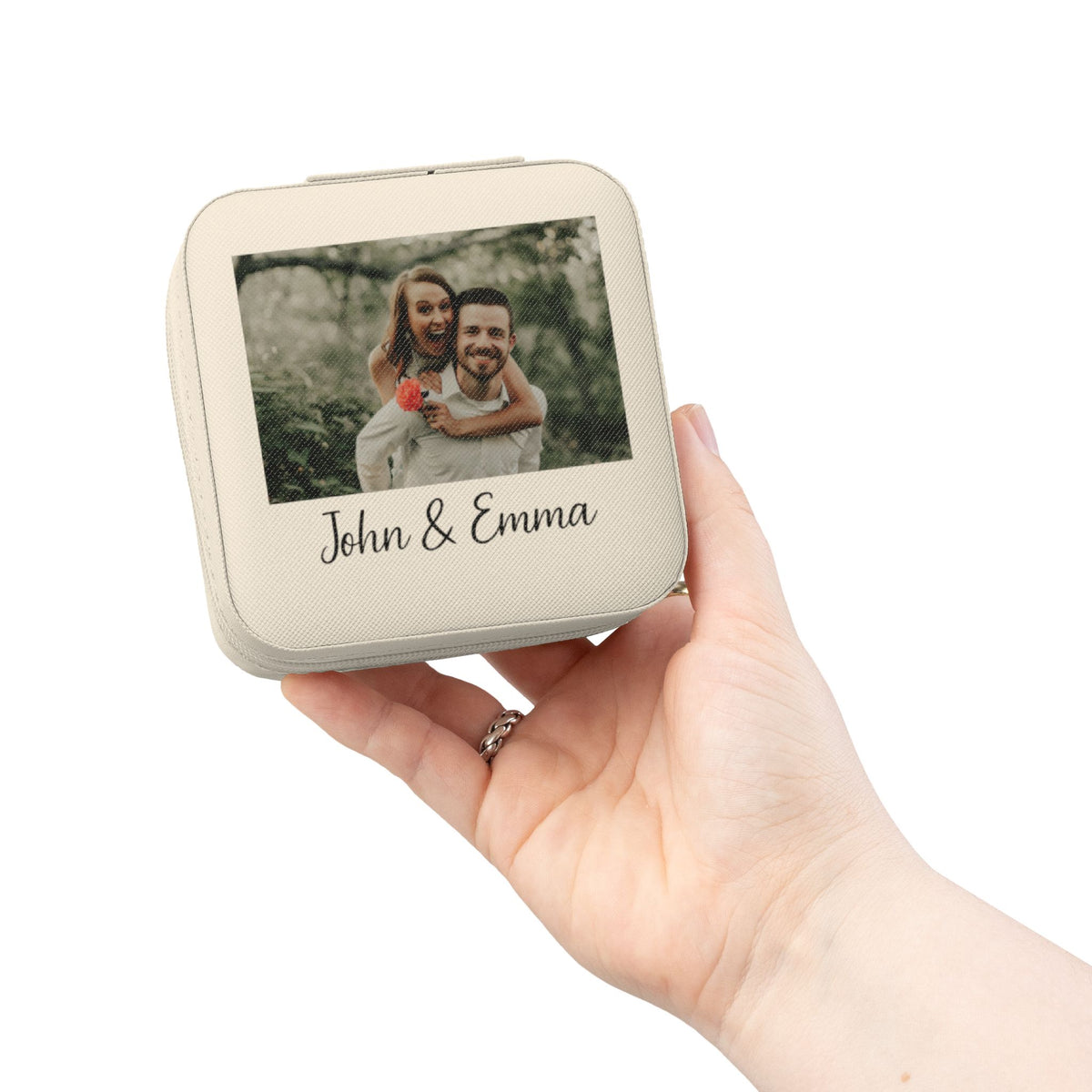 Personalized pink couple's photo jewelry travel case with custom names, held in hand