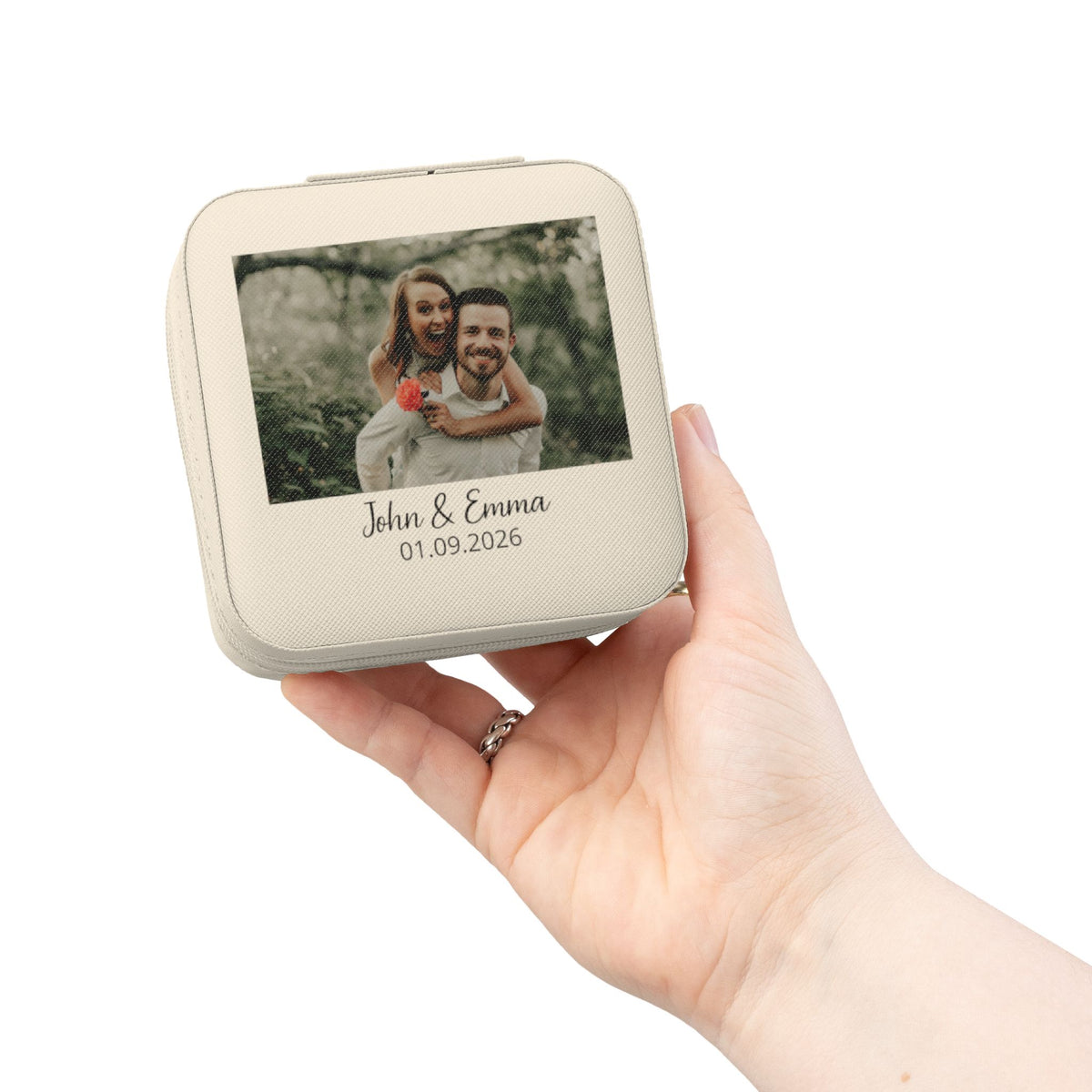Personalized pink photo and date jewelry travel case with custom names, held in hand