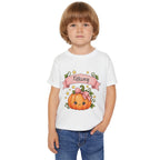 Close-up of pink pumpkin graphic with custom name banner on toddler tee
