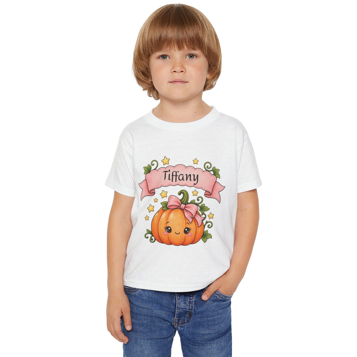 Close-up of pink pumpkin graphic with custom name banner on toddler tee