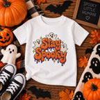 Close-up of Stay Spooky lettering and ghosts graphic on toddler tee