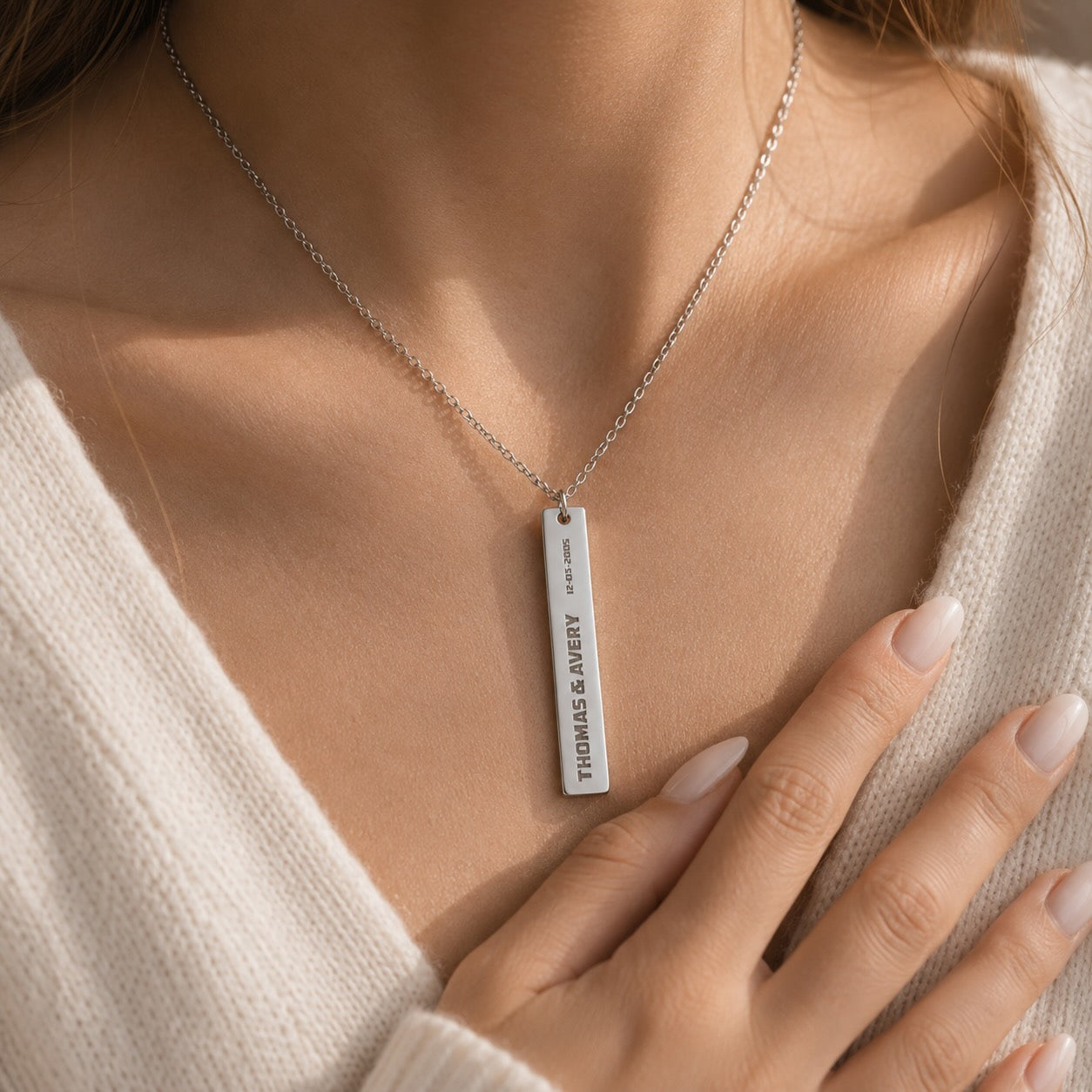 Polished bar necklace close-up of engraved couple names