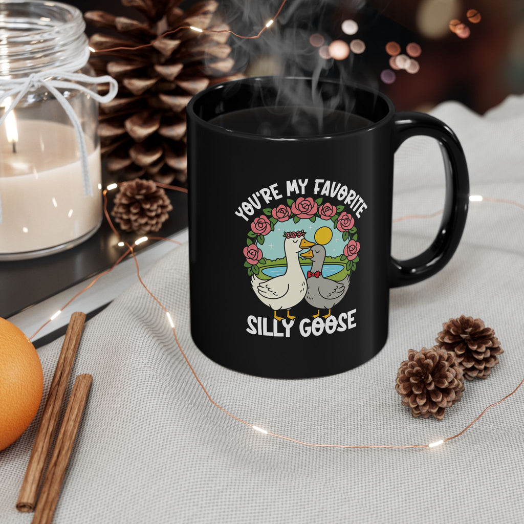 Close-up of goose illustration and floral design on black mug